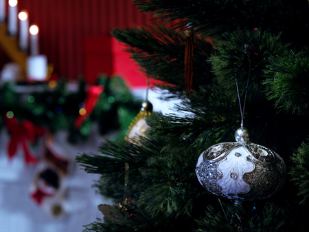 close up view  of lit Christmas tree with toy and fireplace on the backの写真素材