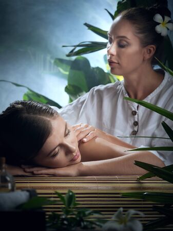 portrait of young beautiful woman in spa environmentの写真素材