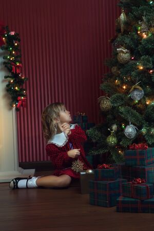 portrait of little girl with gift box in  christmas domestic environmentの写真素材
