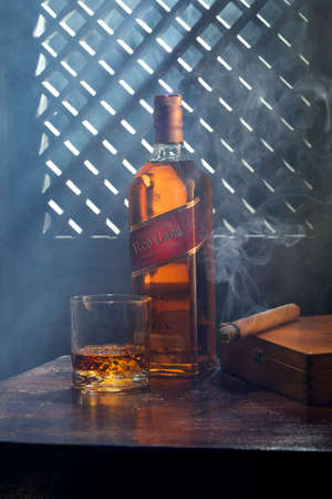 Phuket, Thailand- March 2020. Johnnie Walker Red Label blended whisky on color  background. Johnnie Walker is the most widely distributed brand of blended Scotch whisky in the world.のeditorial素材