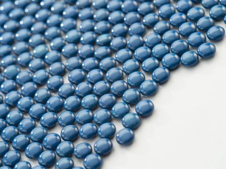 Close up view of blue color pills on white back