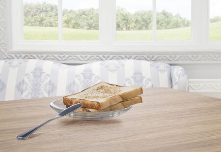 View  of fried  toast with knife on the table on color summer back