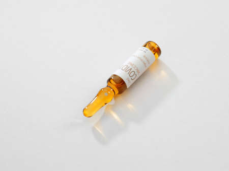 Close up view of the ampule with medicine on white back