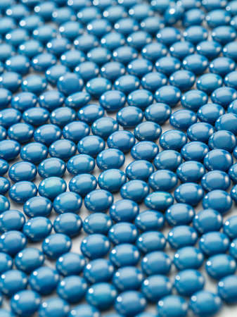 Close up view of blue color pills on white backの写真素材