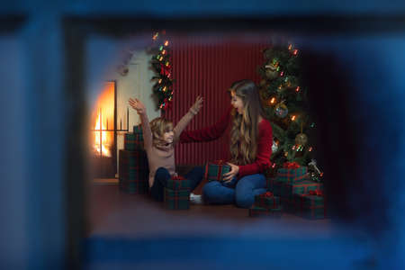 portrait of beautiful little girl with her mama in christmas environmentの写真素材