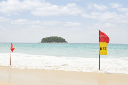 View of warning flag on nice warm tropic beach during law season