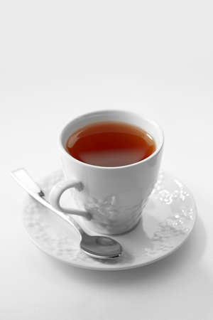 Close up view of white porcelain cup of tea on white backgroundの写真素材