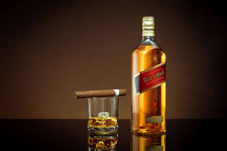 Phuket, Thailand- Feb 2021. Johnnie Walker Red Label blended whisky isolated on color  background. Johnnie Walker is the most widely distributed brand of blended Scotch whisky in the world.のeditorial素材