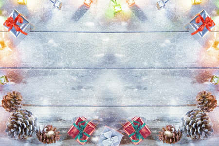 close up view  of lit Christmas tree on snowbound  wooden backの写真素材