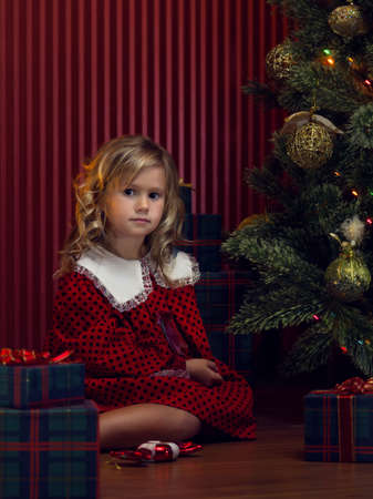 portrait of little girl with gift box in  christmas domestic environmentの写真素材