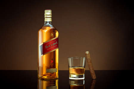 Phuket, Thailand- Feb 2021. Johnnie Walker Red Label blended whisky isolated on color  background. Johnnie Walker is the most widely distributed brand of blended Scotch whisky in the world.のeditorial素材