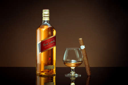 Phuket, Thailand- Feb 2021. Johnnie Walker Red Label blended whisky isolated on color  background. Johnnie Walker is the most widely distributed brand of blended Scotch whisky in the world.のeditorial素材
