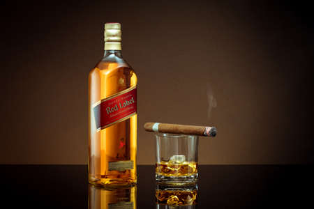 Phuket, Thailand- Feb 2021. Johnnie Walker Red Label blended whisky isolated on color  background. Johnnie Walker is the most widely distributed brand of blended Scotch whisky in the world.のeditorial素材