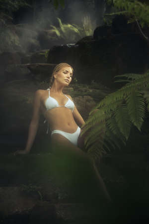 Portrait of young attractive woman having good time in jungleの写真素材