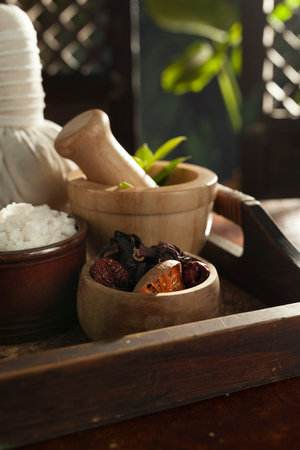 close up view of mortar, salt, oil and Herbal Compress on color back.の写真素材