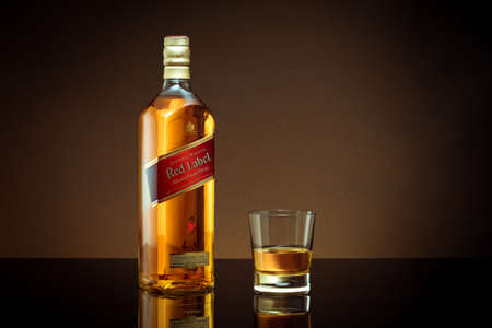 Phuket, Thailand- Feb 2021. Johnnie Walker Red Label blended whisky isolated on color  background. Johnnie Walker is the most widely distributed brand of blended Scotch whisky in the world.のeditorial素材