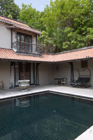 view of oriental  style house with swimming pool in the middleのeditorial素材