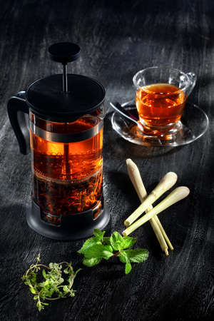 close up view of french press and a cup of green tea on grey backgroundの写真素材