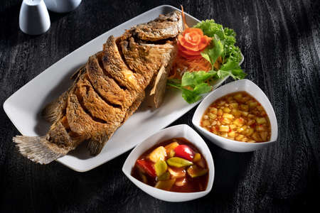 close  up view of nice yummy fish on dark backの写真素材