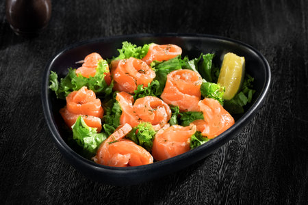 close  up view of nice yummy salmon salad in grey backの写真素材