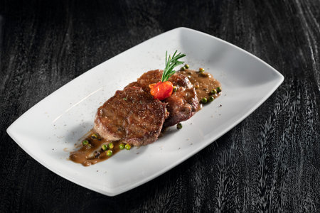 close  up view of nice yummy fresh steak on grery backの写真素材