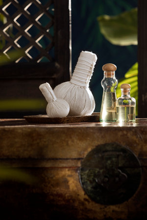 close up view of   Herbal massage Compress and oil on green back.の写真素材