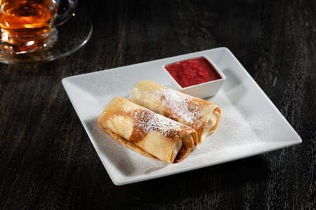 close up view of nice yummy crepes with jam on grey tableの写真素材