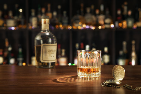 close up view of bottle of whiskey and glass aside on color back.の写真素材