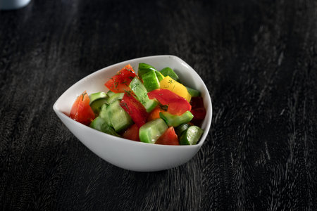 close up view of fresh vegetable salad on grey backgroundの写真素材