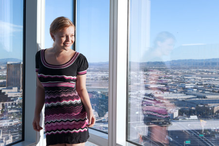 Portrait of a nice girl in sun light in office environmentの写真素材