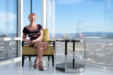 Portrait of a nice girl in sun light in office environmentの写真素材