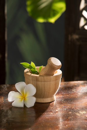 close up view of spa wooden mortar on color backの写真素材