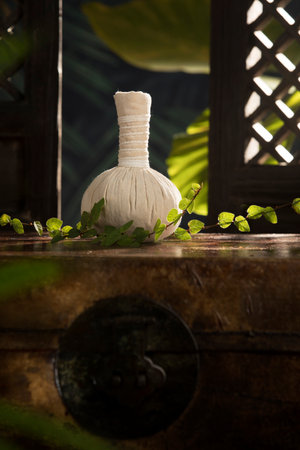 close up view of   Herbal massage Compress on green back.の写真素材