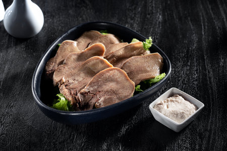 View of nice yummy beef tongue stew on grey backの写真素材