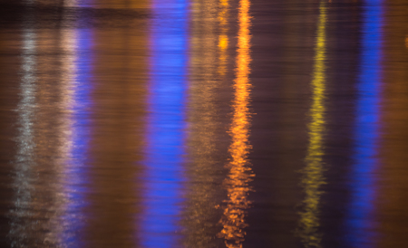 Lights reflecting in rippled sea water surface