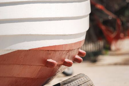 White and red wooden fishing boat detail. Shot with a selective focus.の写真素材