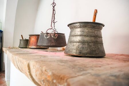 Vintage kitchen utensils are hanging on the wall. Selective focus.の写真素材