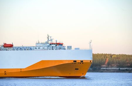 Yellow white cargo ship sailing in the sea