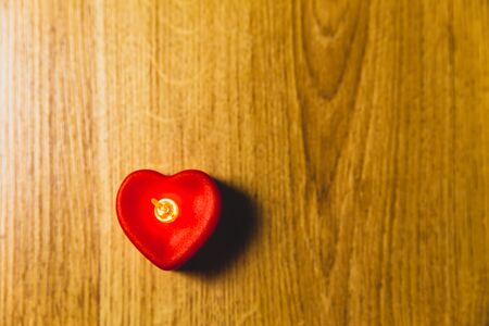 Red heart shape light on the wooden background for Valentine's Day.の写真素材
