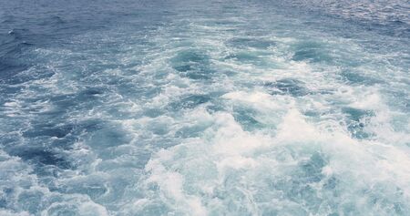 Water with boat trace. Water foam trace behind the ship.