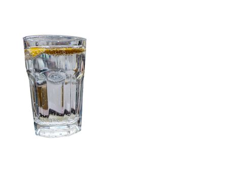 glass of sparkling water with lemon slices isolated on white. drink and refreshment conceptの写真素材