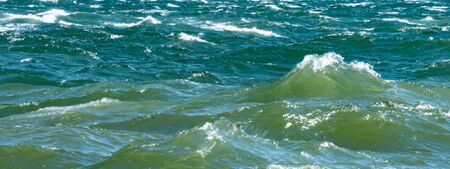 Waves hit the hard surface of concrete slabsの写真素材