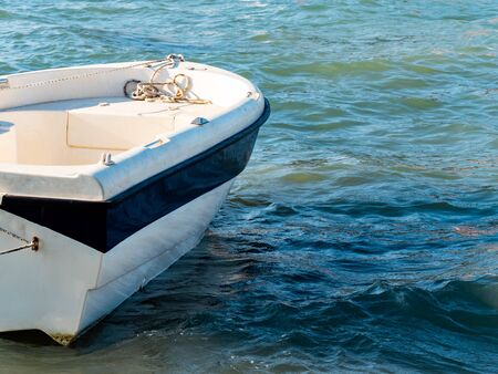Small fishing boat floating on the sea water.
