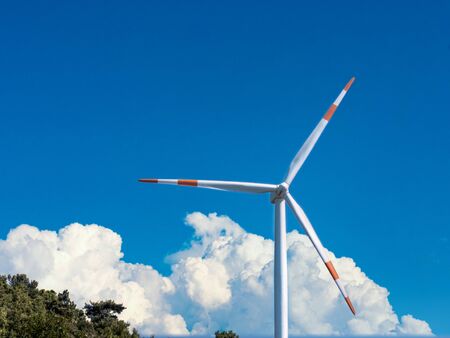 Wind turbine with beautiful clouds on the sky background. Renewable alternative energy.