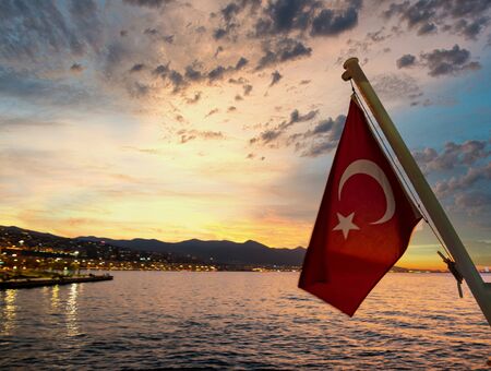 A Turkish flag flying off the back of a ferry boat in izmir, Turkey. Travel Turkey.の写真素材