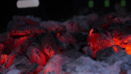 Close up view of smouldering charcoal coals in the grill. Shallow depth of field.の写真素材