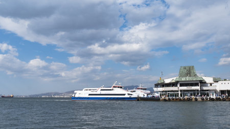 Izmir, Turkey - October 2017: People getting and or boarding to the ferry in izmir city. Ferry is carrying passengers from Konak ferry terminal to Karsiyaka ferry terminal at izmir, Turkey.のeditorial素材