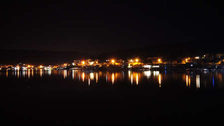Night scene with light and reflection at Balikliova, Urla, izmir, Turkeyの写真素材