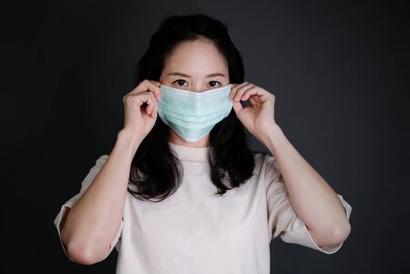 Girl with mask to protect her from virus or pollutionの写真素材