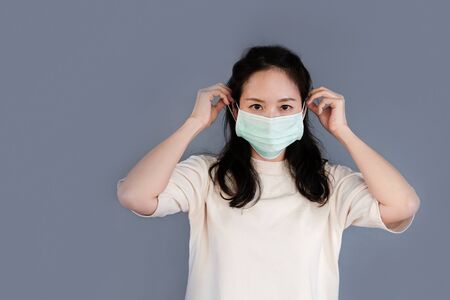 Girl with mask to protect her from virus or pollutionの写真素材